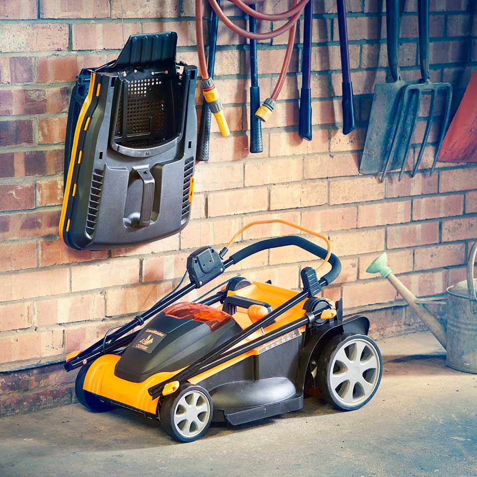 LawnMaster Cordless Lawn Mower 48V 41cm stored compactly in garage CLMF4841E