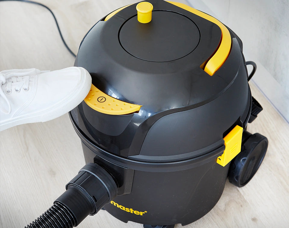 Vacmaster D8 Vacuum Cleaner power button being turned on with foot