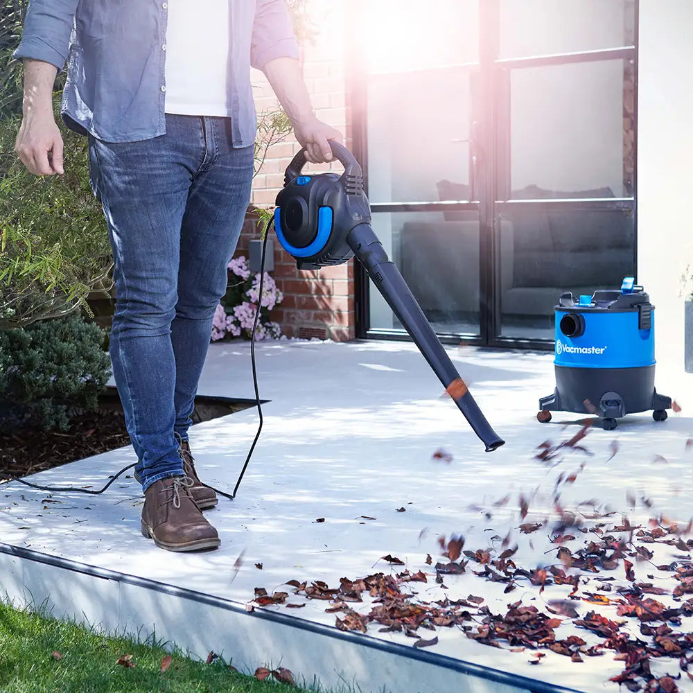 Vacmaster 2-in-1 Wet Dry Vacuum blower blowing leaves on patio VBVB1223PF 03